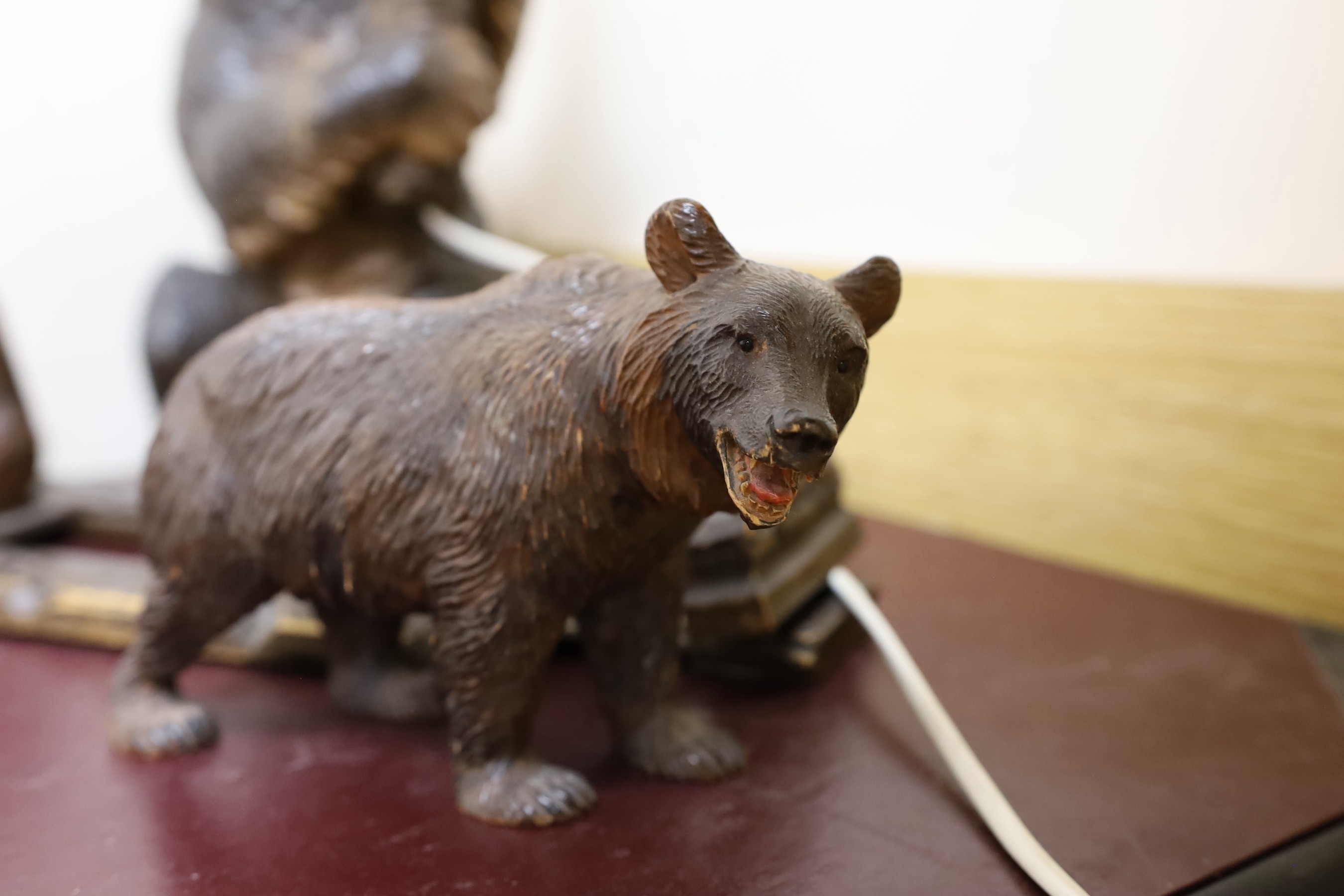 A group of Black Forest carved wood bears: a lamp, a book rack, etc.